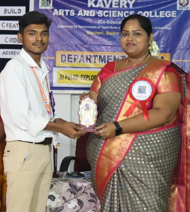 Mano receiving an award from the presenter at a Kavery Arts and Science College event